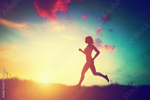 Silhouette of woman running at sunset