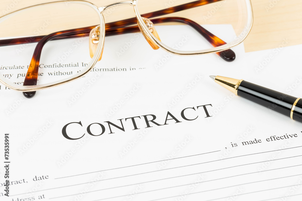 Business contract document with pen and glasses Business contract document with pen and glasses