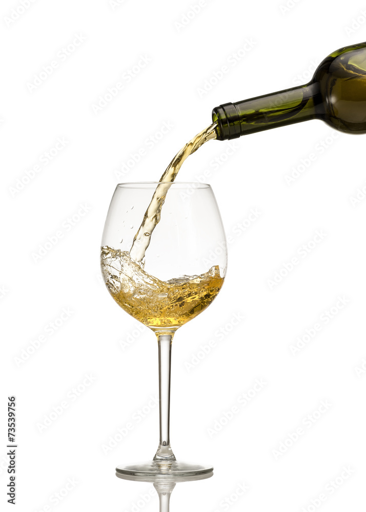White wine being poured into wine glass White wine being poured into wine glass