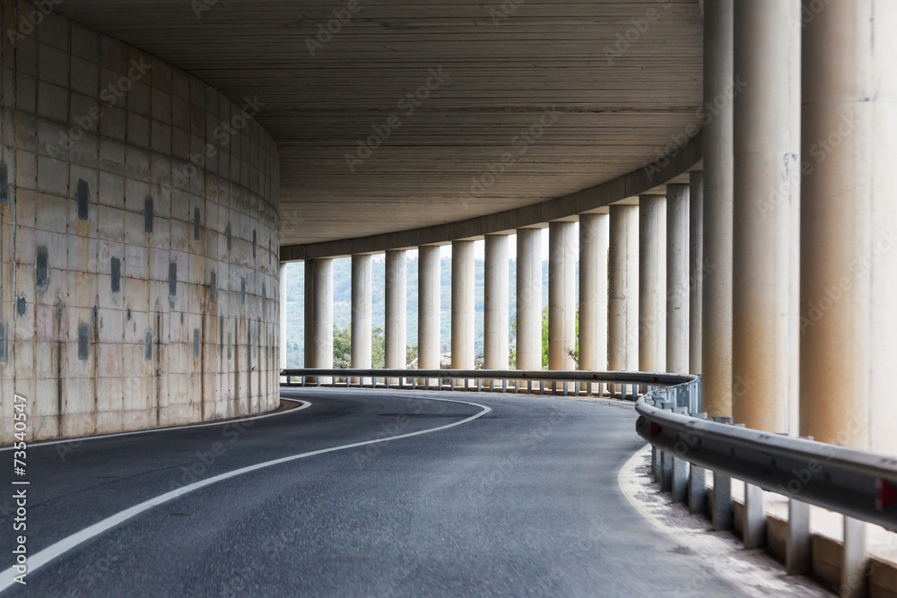bend of the road in a tunnel with columns