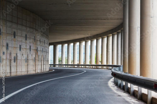 bend of the road in a tunnel with columns