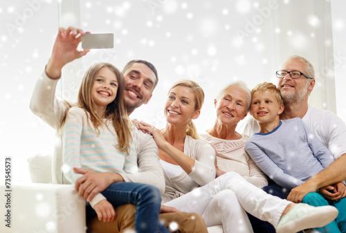 happy family taking selfie with smartphone at home