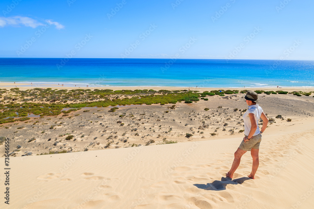 Woman standing on sand dune, Sotavento beach, Fuerteventura