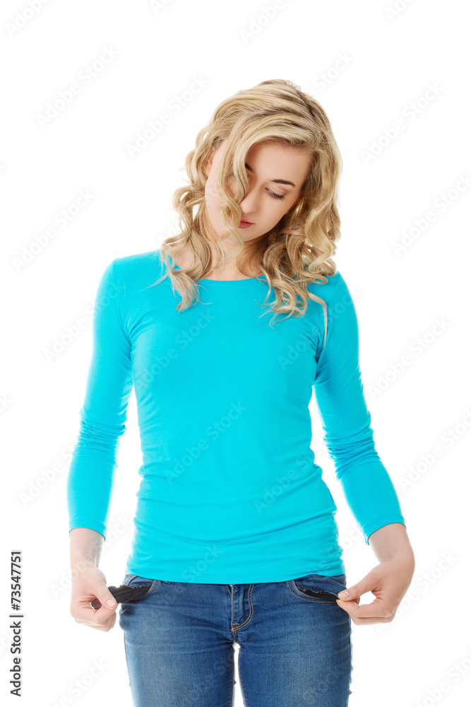 Sad woman showing her empty pockets Sad woman showing her empty pockets