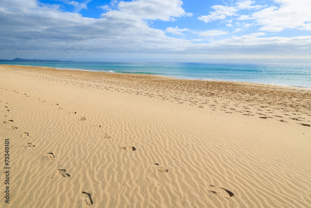Footprints in sand on Morro Jable beach, Fuerteventura island