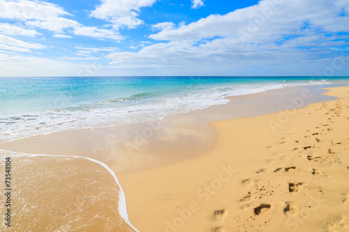 Footprints in sand on Morro Jable beach, Fuerteventura island