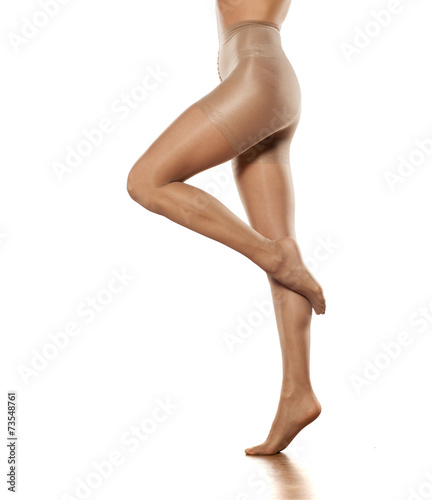 Pretty female legs in stockings on a white background