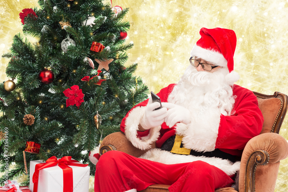 santa claus with smartphone and christmas tree santa claus with smartphone and christmas tree