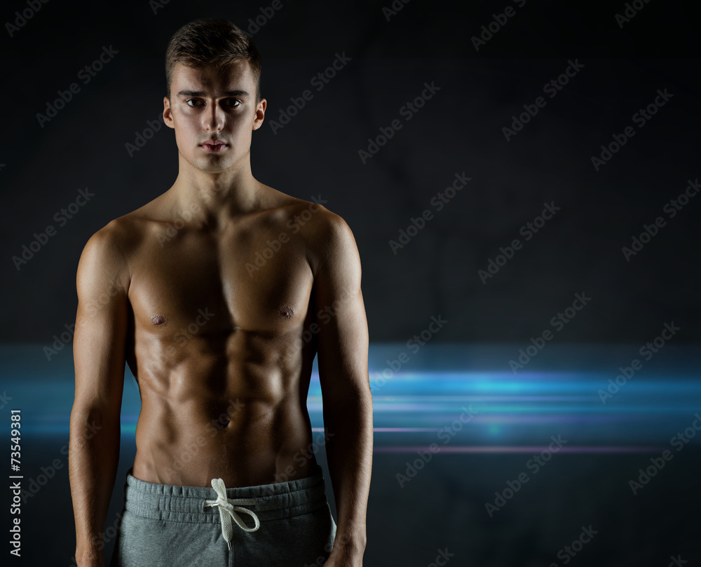 young male bodybuilder with bare muscular torso