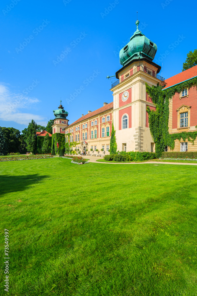 Green gardens of Lancut castle on sunny summer day, Poland
