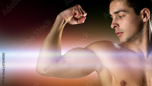 close up of young man flexing and showing biceps