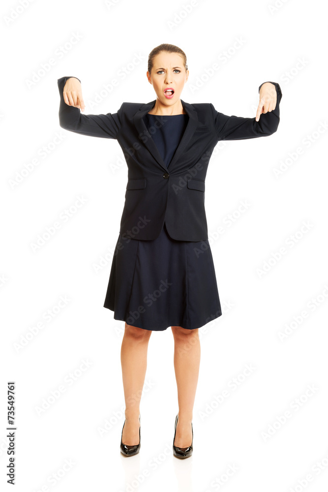Pretty businesswoman pointing down Pretty businesswoman pointing down