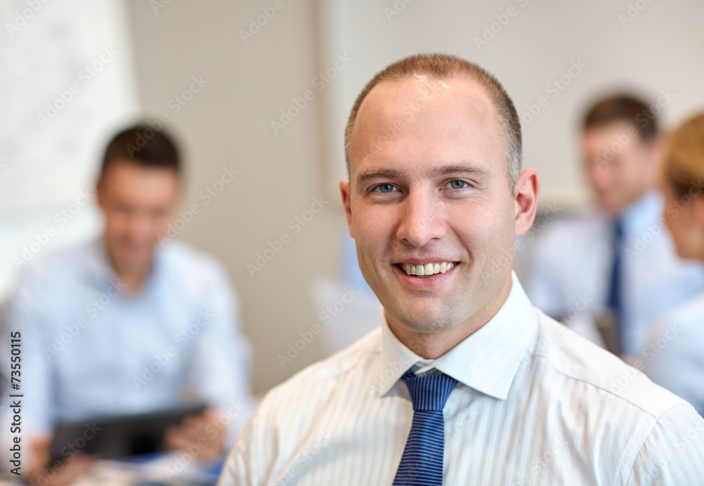 group of smiling businesspeople meeting in office group of smiling businesspeople meeting in office