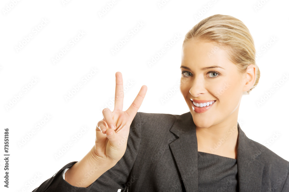 Happy businesswoman showing victory sign Happy businesswoman showing victory sign