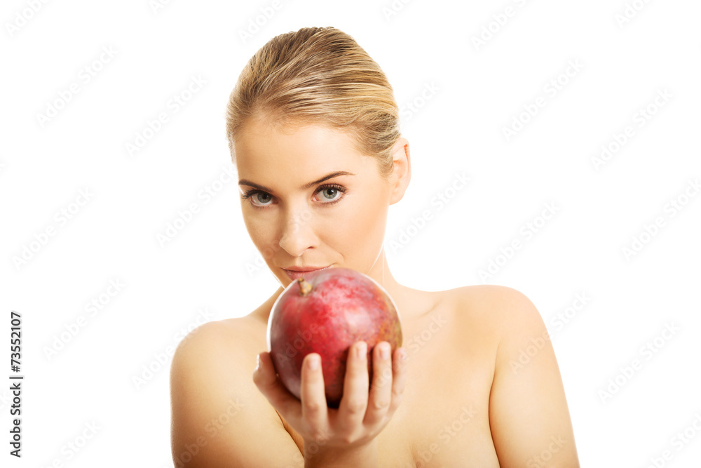 Nude woman giving a mango