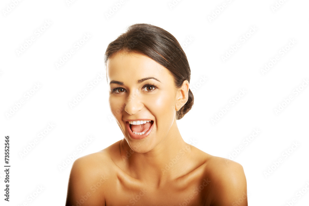 Portrait of nude woman laughing loud