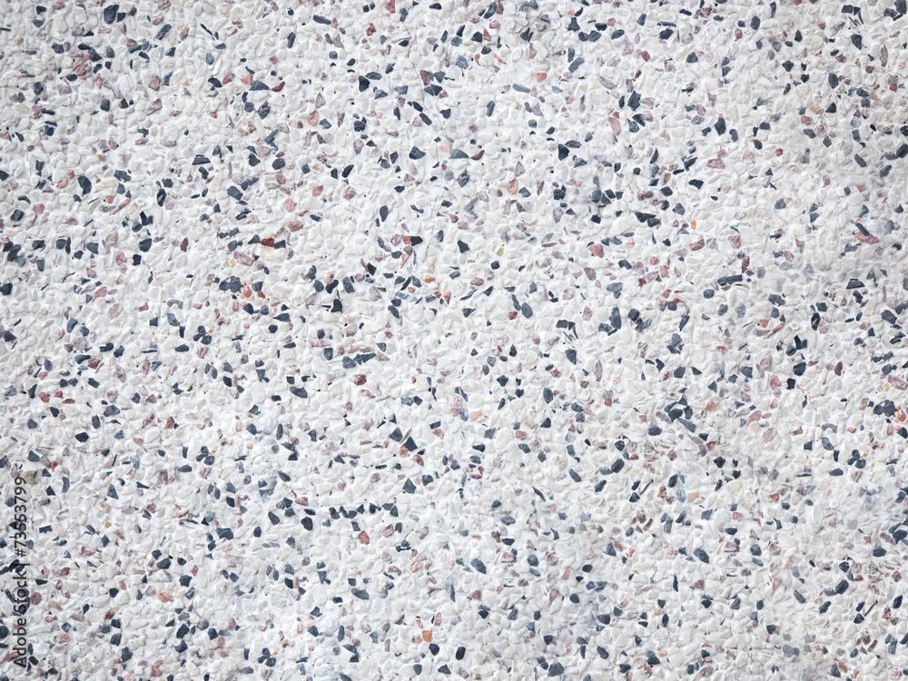 Mosaic of mix pebbles on white wall background Mosaic of mix pebbles on white wall background