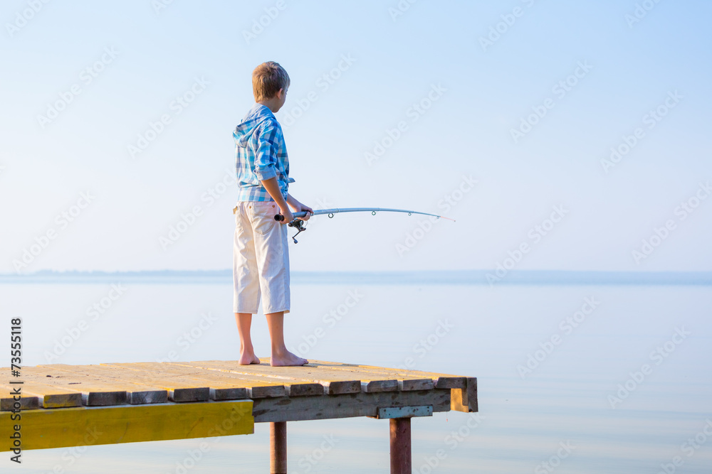 Boy in blue shirt standing on a pie Boy in blue shirt standing on a pie