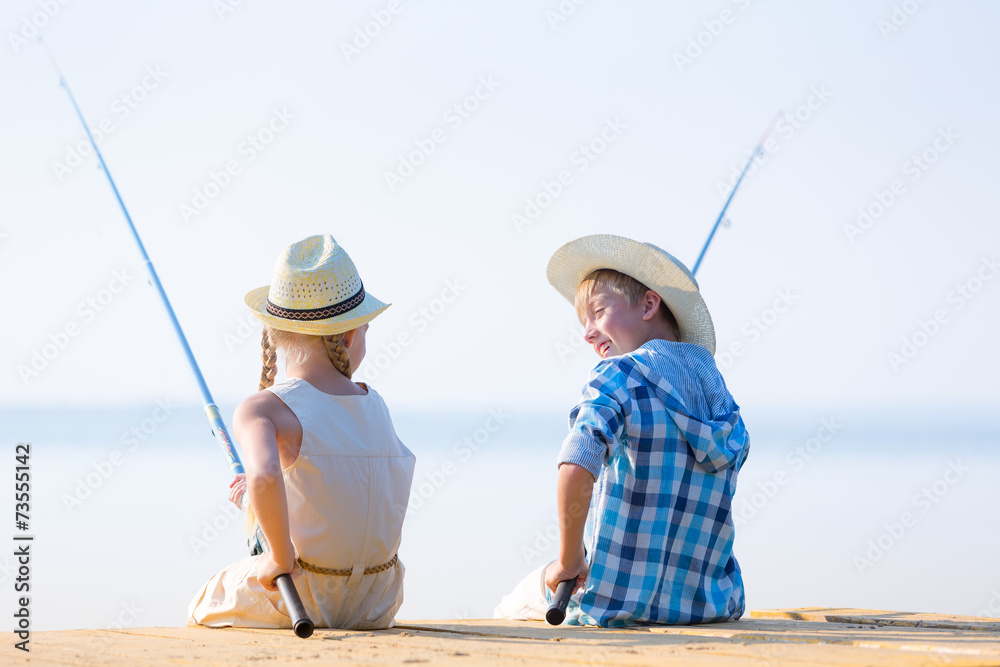 Boy and girl with fishing rods Boy and girl with fishing rods