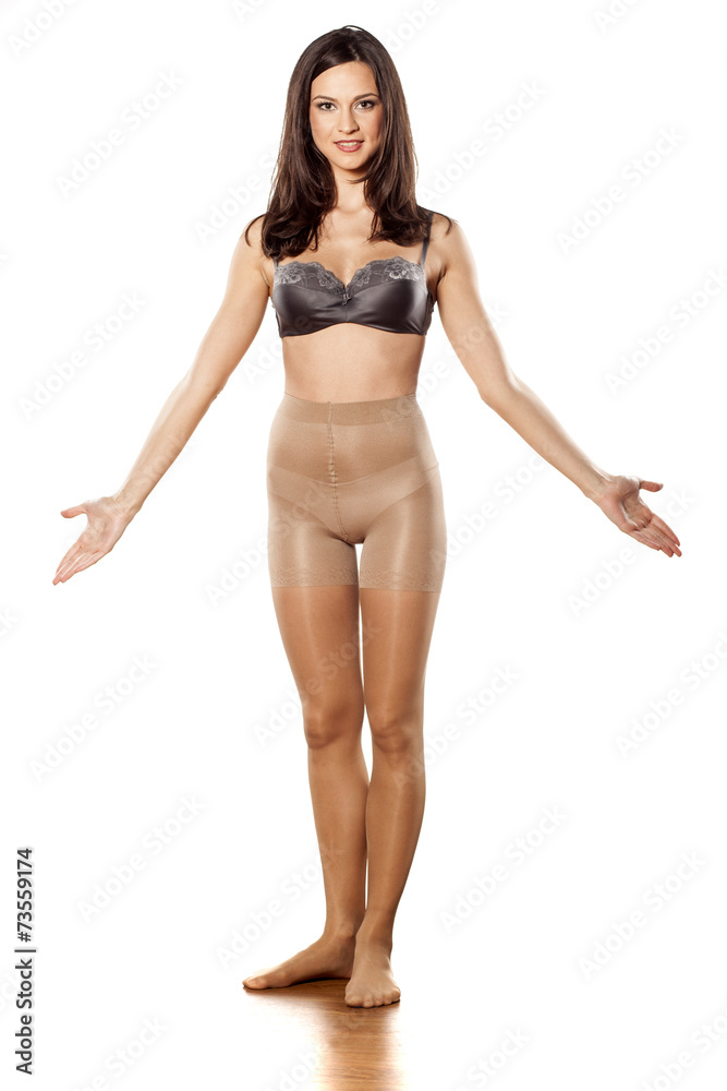 young woman in nylon stockings and bra on a white background Stock Photo