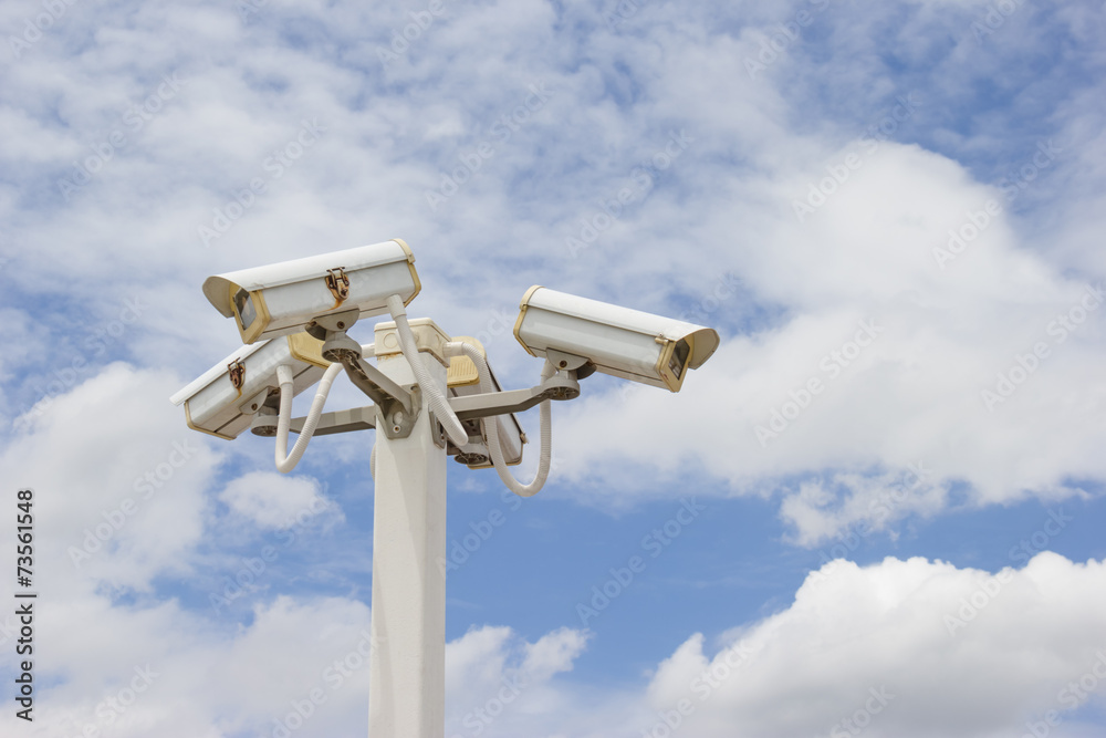 CCTV Camera in cloudy blue sky background. CCTV Camera in cloudy blue sky background.
