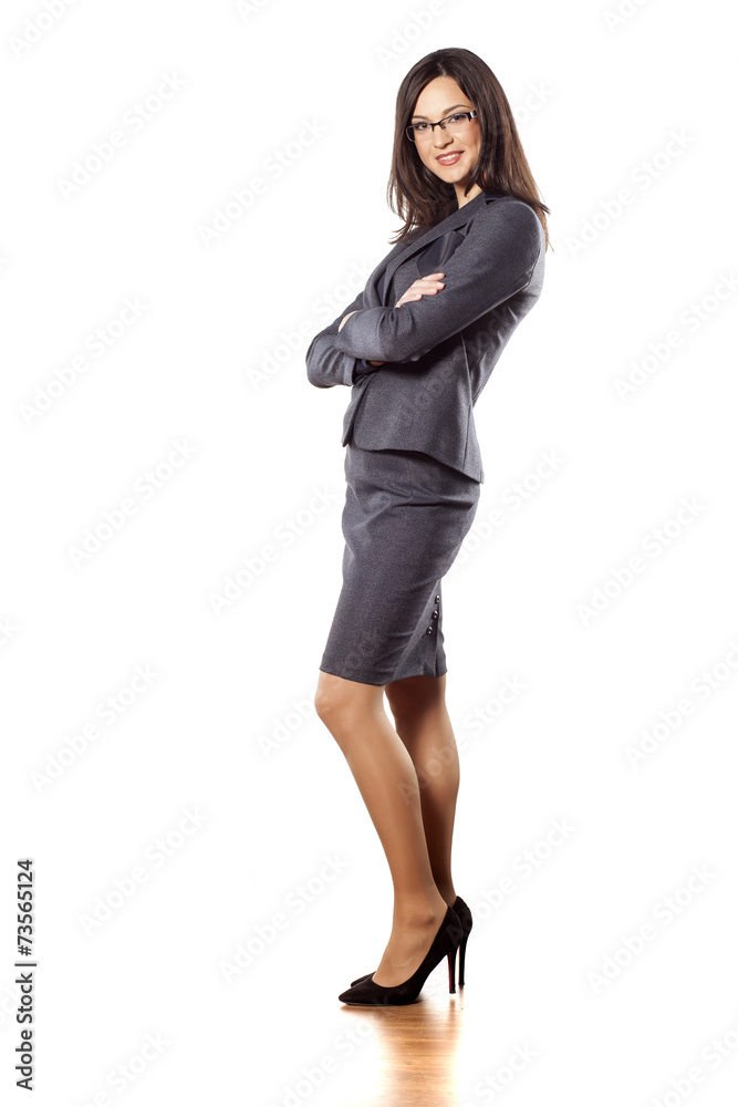 pretty young businesswoman posing with arms folded pretty young businesswoman posing with arms folded