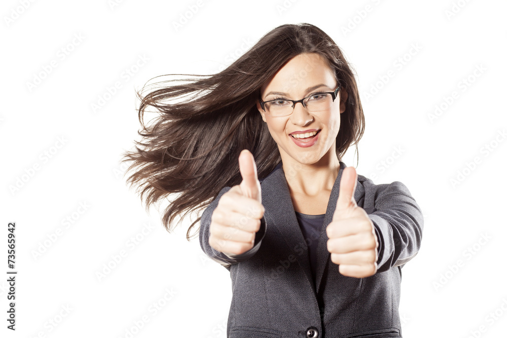 young businesswoman with the wind in her hair showing thumbs up
