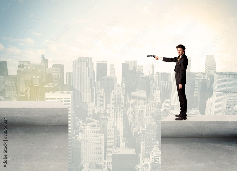 Businessman standing on the edge of rooftop Businessman standing on the edge of rooftop