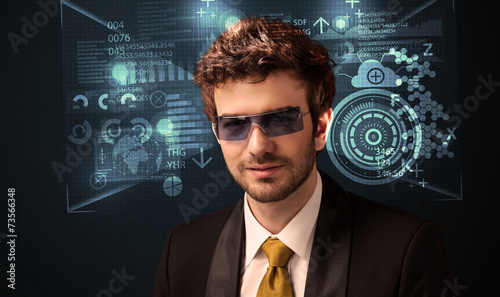 Young man looking with futuristic smart high tech glasses