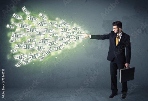 Business person throwing a lot of dollar bills concept
