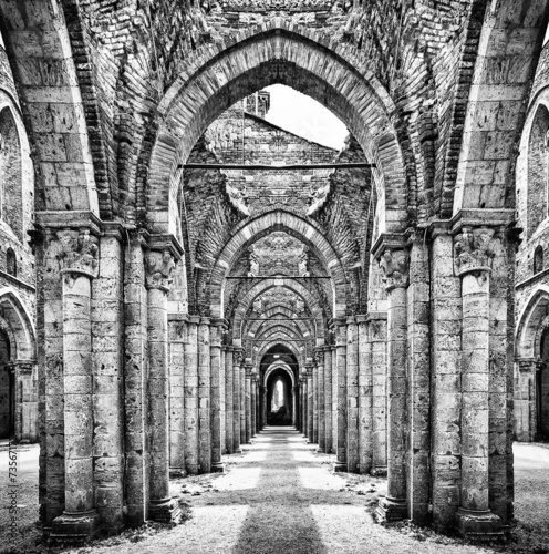 Historic ruins of abandoned abbey in black and white #73567171