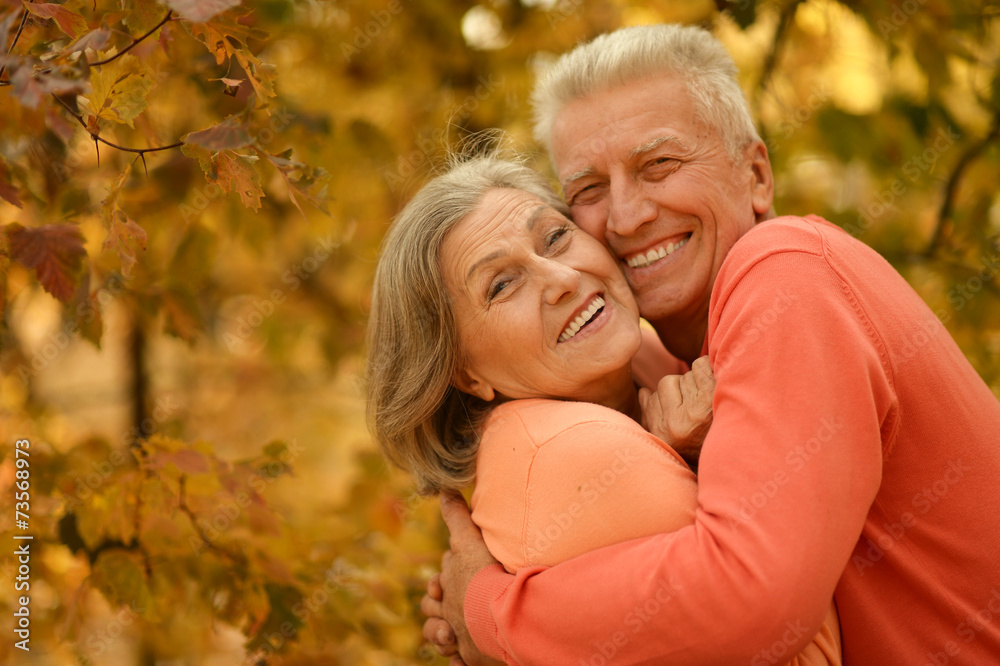 Old couple posing at autumn park