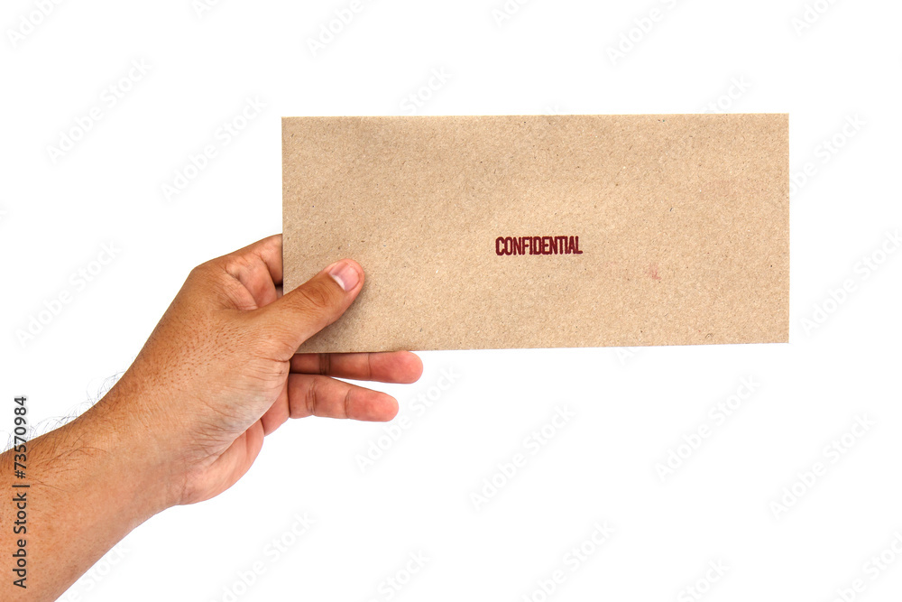 Hand holding Brown envelope with confidential stamp Hand holding Brown envelope with confidential stamp