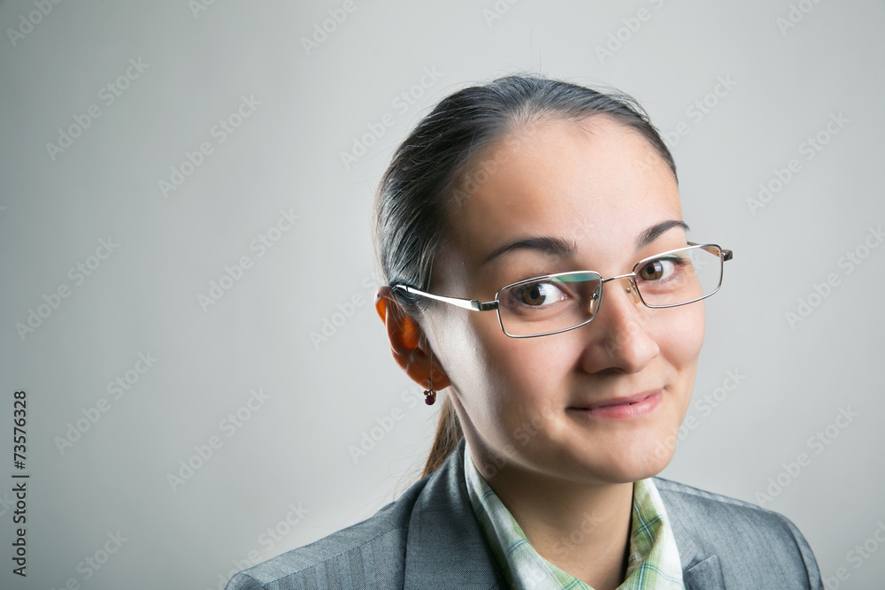 Confident woman looking through her spectacles Confident woman looking through her spectacles