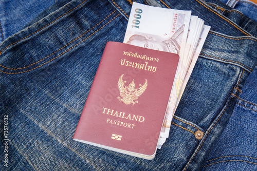 Thailand Passport and money in denim jeans pocket