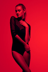 sexy girl in black lingerie on red background