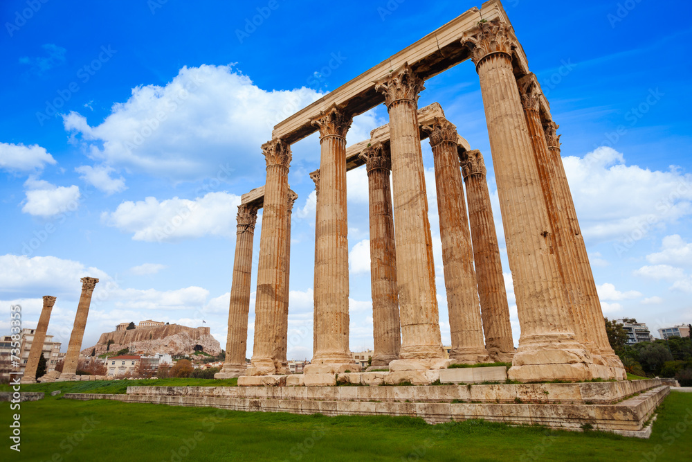 View of Zeus temple on green grass in Athens View of Zeus temple on green grass in Athens