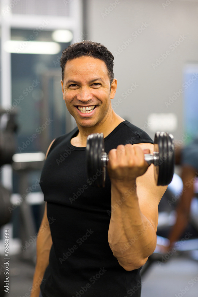 athletic man excising with dumbbells athletic man excising with dumbbells