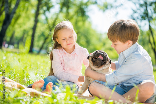 Children in park with pet © adam121