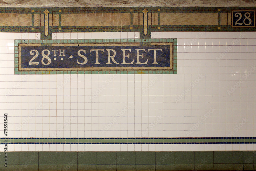 Fototapeta premium New York City Station subway 28th Street sign on tile wall.