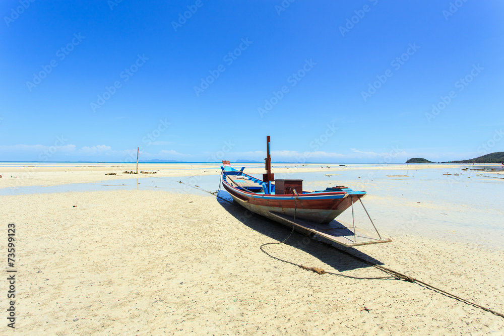 Traditional Thai boat or long tail boat stand at the beach Traditional Thai boat or long tail boat stand at the beach
