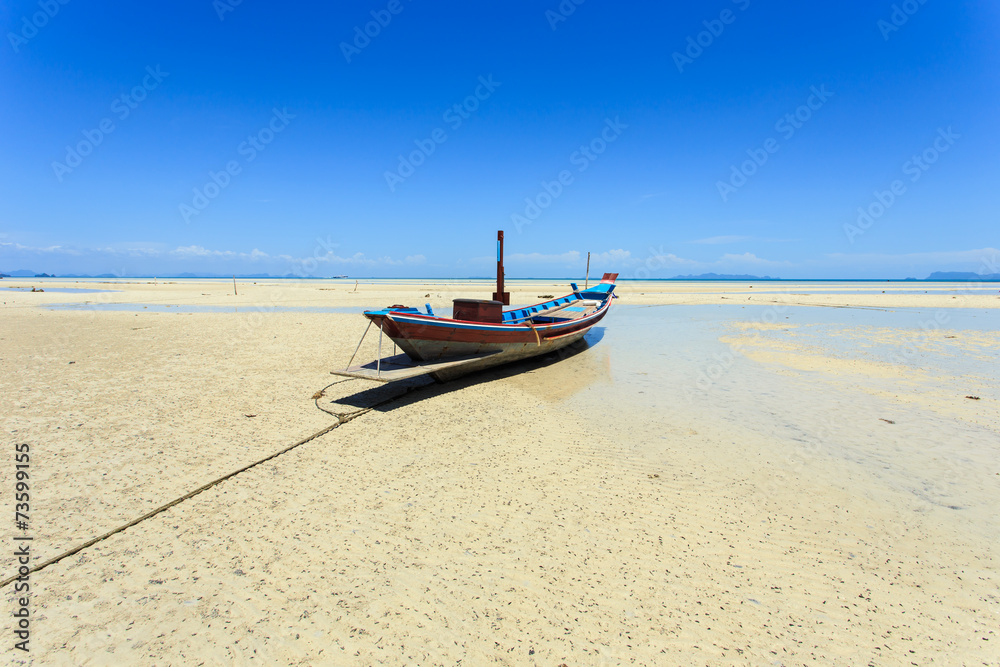 Traditional Thai boat or long tail boat stand at the beach Traditional Thai boat or long tail boat stand at the beach