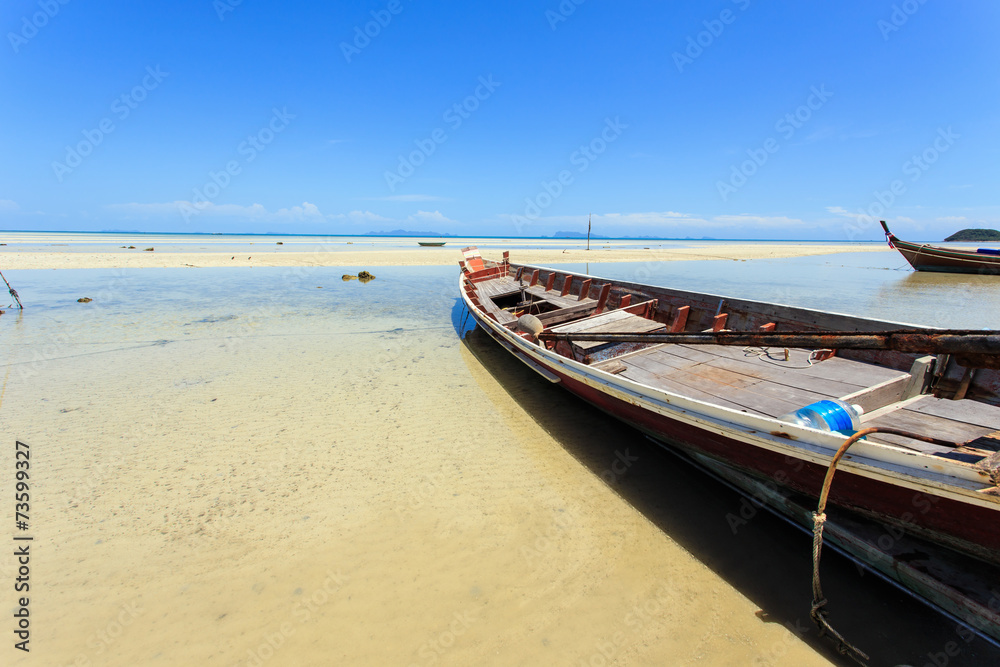 Traditional Thai boat or long tail boat stand at the beach