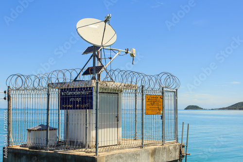 Tableau sur toile satellite dish at tidal gauge station with text in Thai language