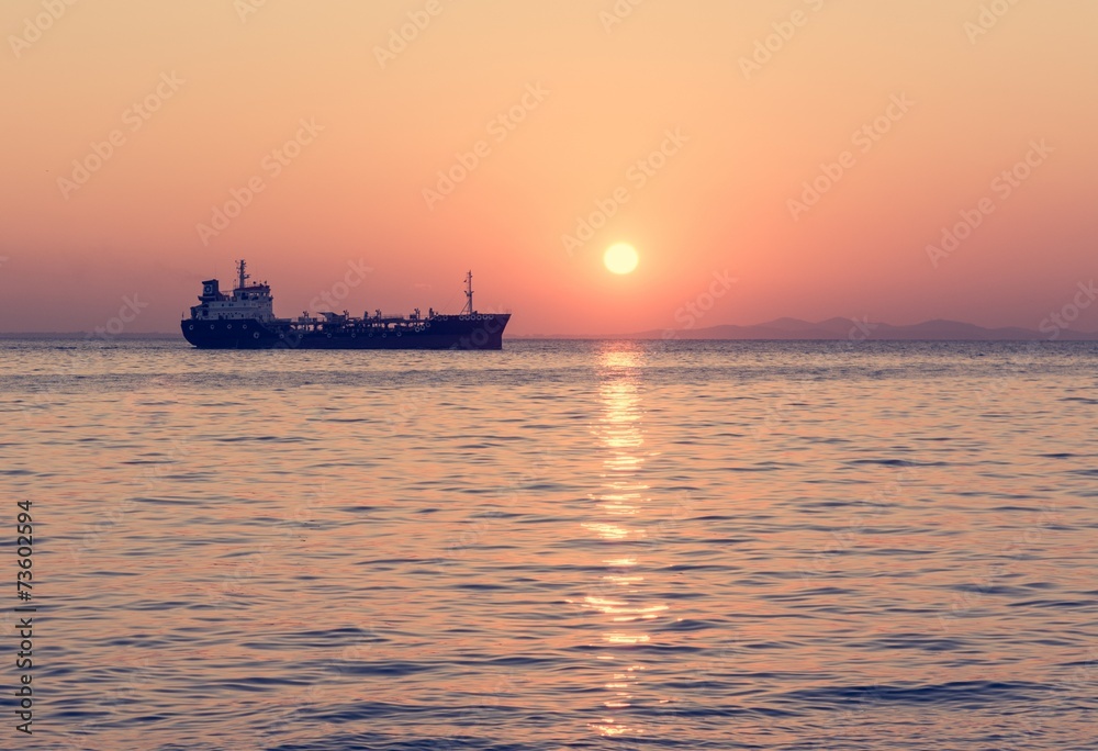 Cargo ship with setting sun