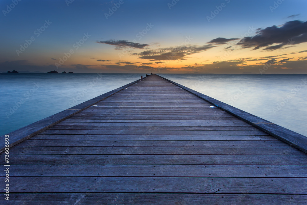 Wood bridge to the sea at sunset beach in Koh Samui, Thailand