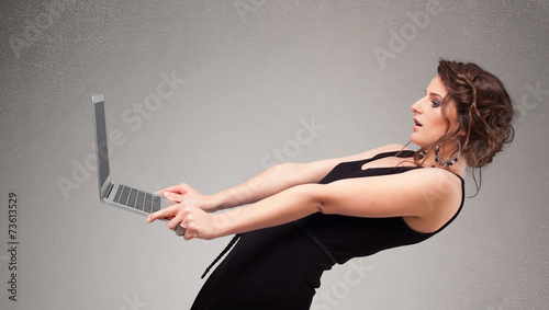 Young woman holding modern laptot photo