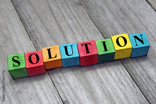 concept of solution word on wooden colorful cubes