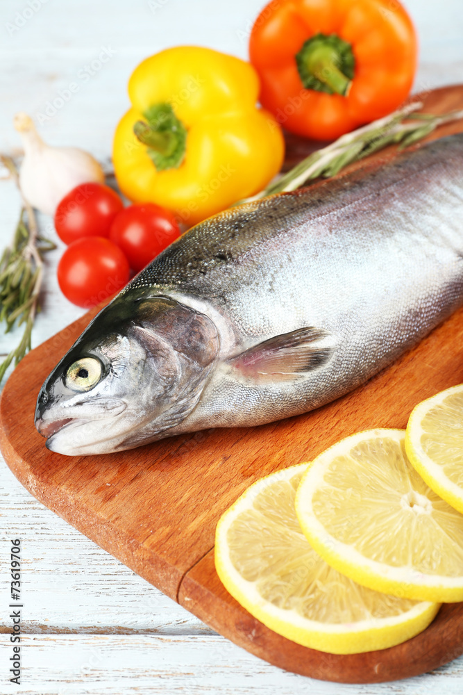 Fresh raw fish and food ingredients on table Fresh raw fish and food ingredients on table