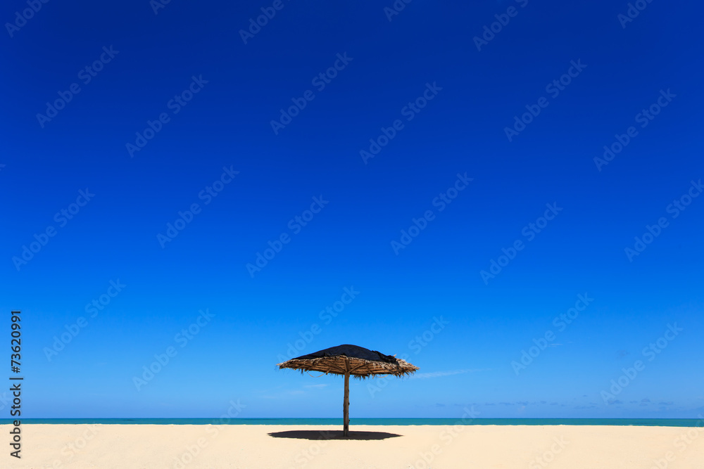 Wooden sun umbrella on the beach in Thailand